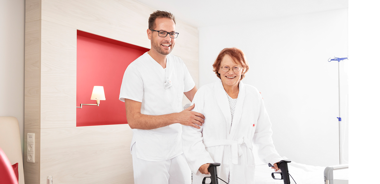 HGZ | Für Patienten Dies ist ein Pfleger der einer älteren Patientin hilft.